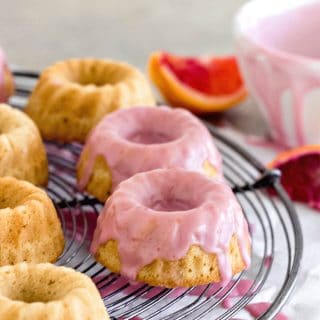 Glazed Blood orange sour cream mini bundt cakes on a wire rack