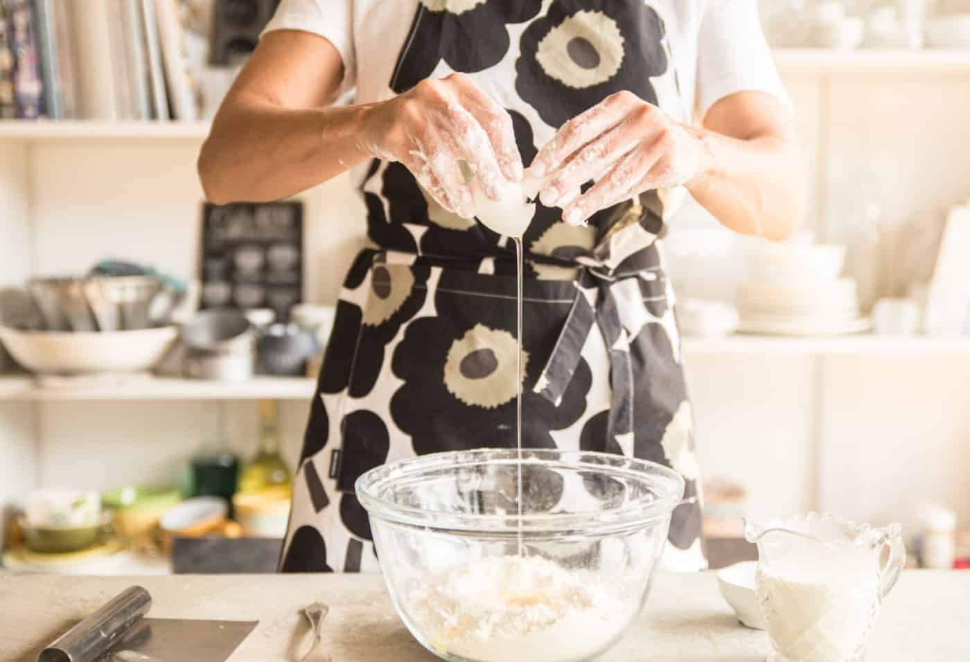 Cracking egg over flour for scones