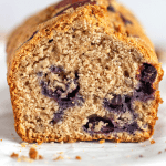 close-up blueberry applesauce loaf cake on white surface