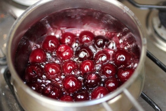 Saucepan with cherry sauce in the making.