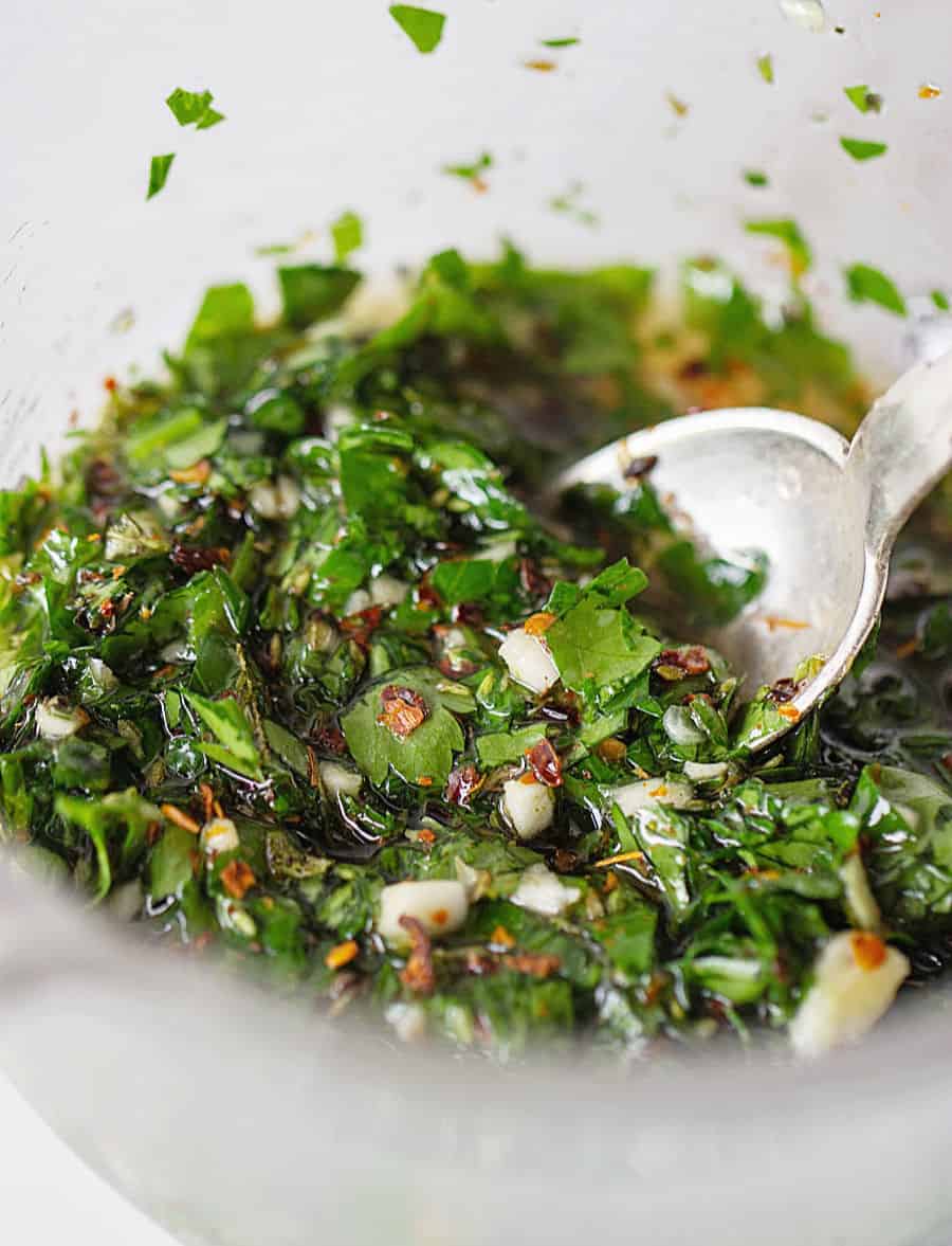 Spooning chimichurri sauce, close up image