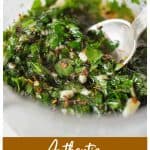 Metal spoon in jar with chimichurri sauce