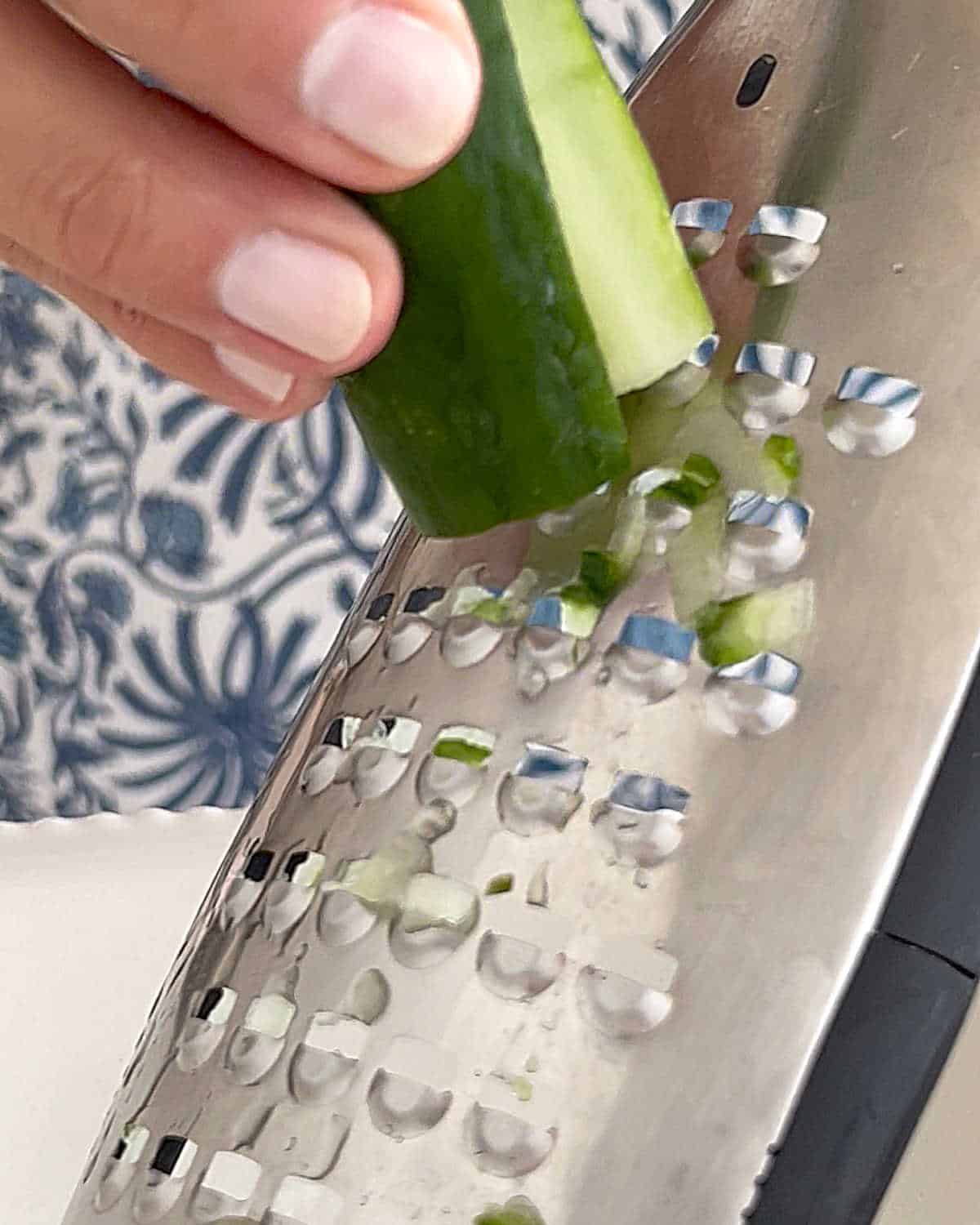 Grating cucumbers with a coarse or large holed grater.
