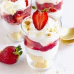 Close up glasses with strawberry cream trifles. White background.