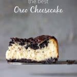 Slice of creamy Oreo Cheesecake on a cake server, grey background