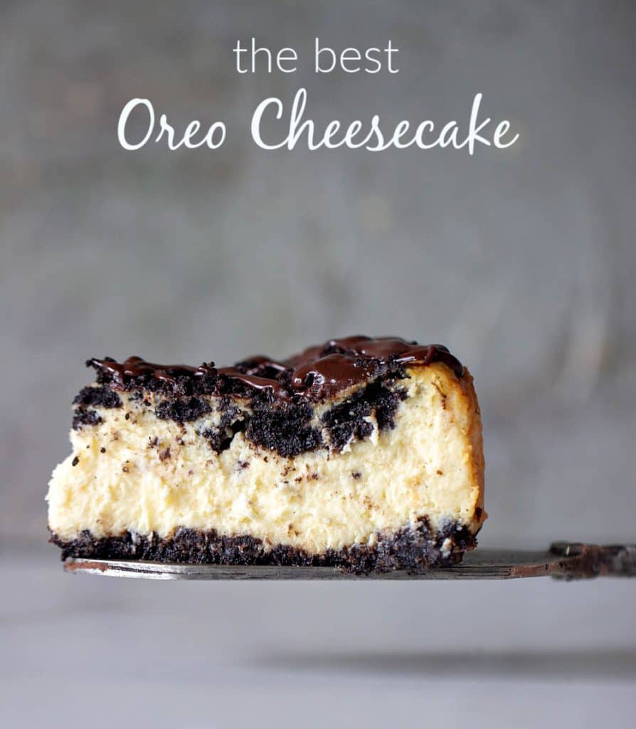 Slice of creamy Oreo Cheesecake on a cake server, grey background