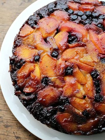 Partial overview of upside down cake on white plate