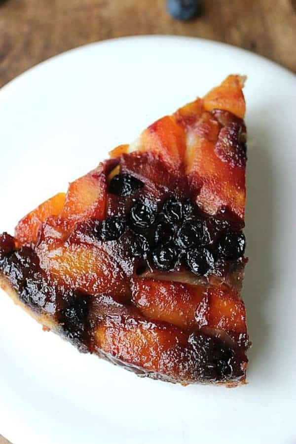 Single slice of Peach Blueberry Upside Down Cake on white plate