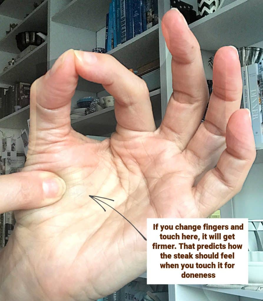 Hand with white and brown text overlay.