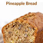 Loaf of zucchini cake on wooden board, slices, white napkin with text