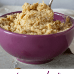 Spooning frangipane from purple bowl, grey background, white cloth, scattered almonds. With text