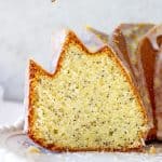 Cut poppy seed bundt cake on white plate