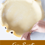 Hands lining pan with sweet shortcrust pastry