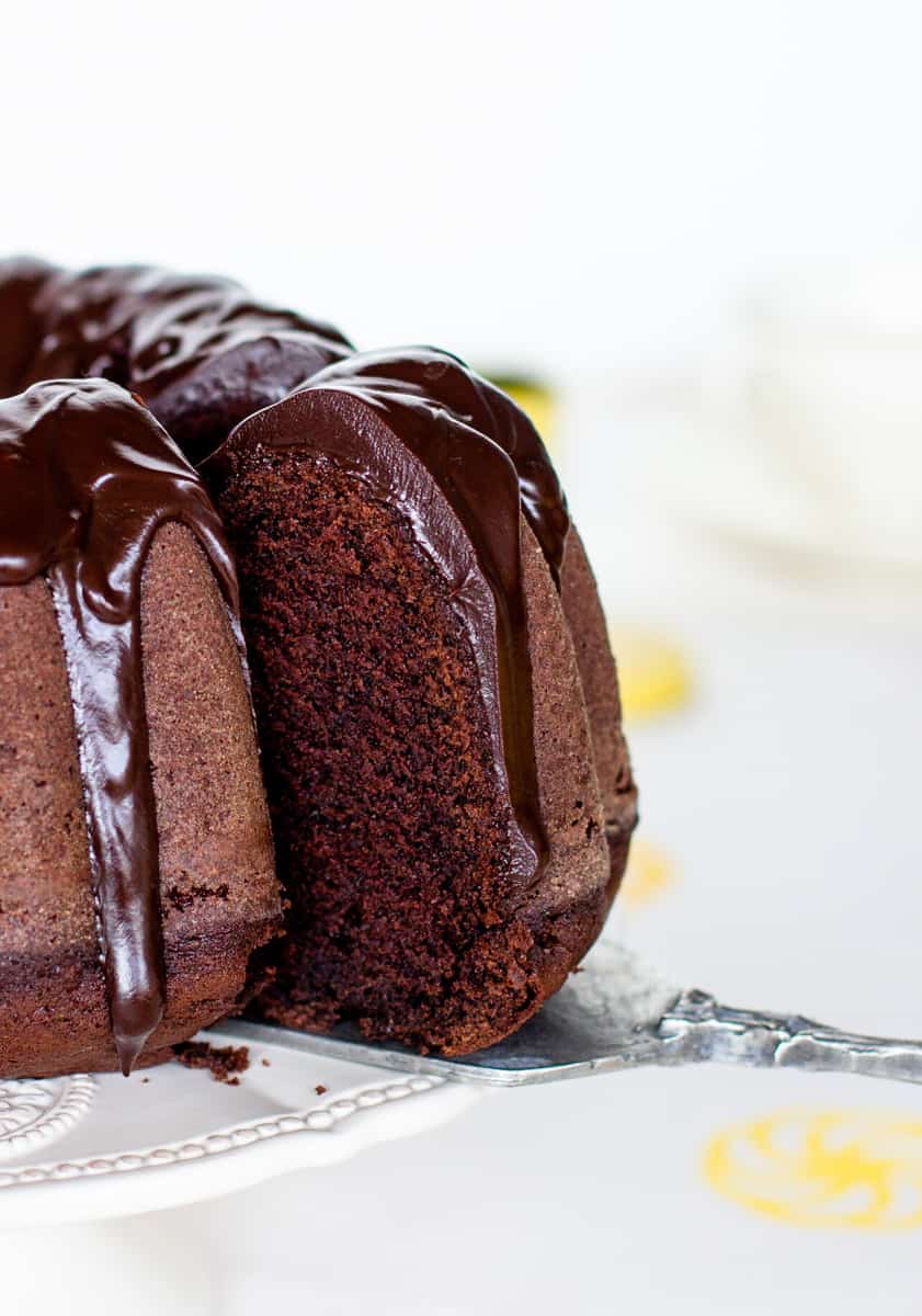 Removing slice from glazed chocolate bundt cake