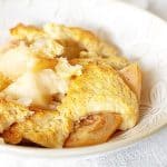 Serving of pear cobbler in a white bowl.