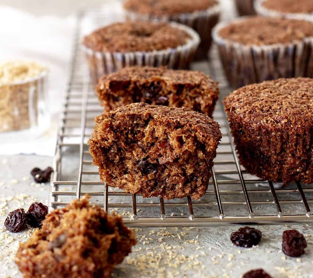 Cut bran muffin on wire rack with whole muffins, loose raisins