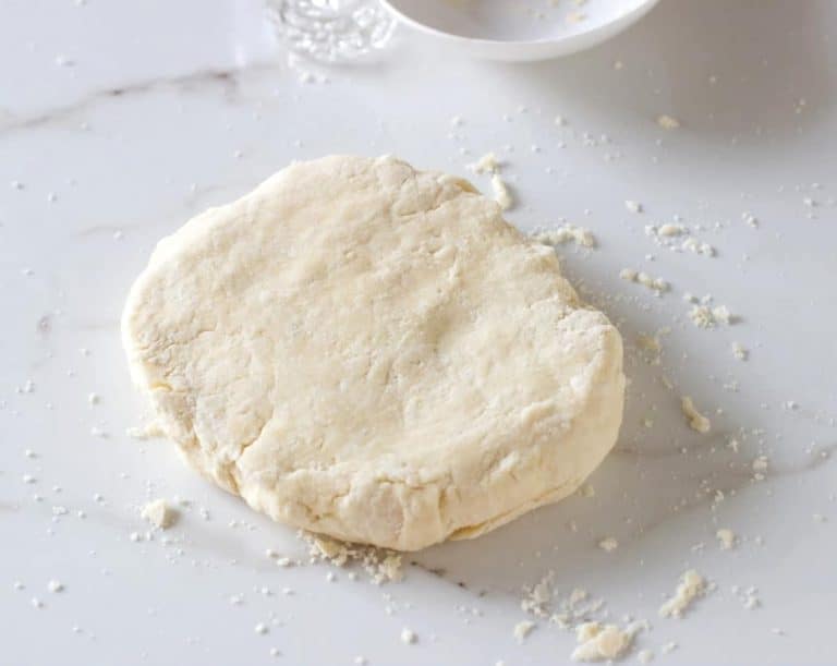 Disc of shortcrust pastry on white surface