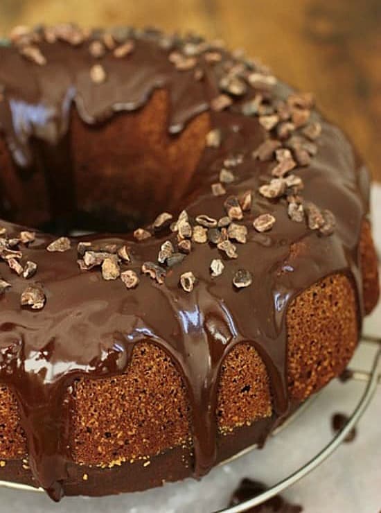 Partial image of whole chocolate bundt cake on wire rack.