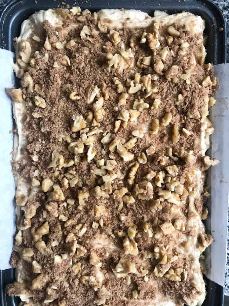 Air view of unbaked apple walnut crumble cake in pan