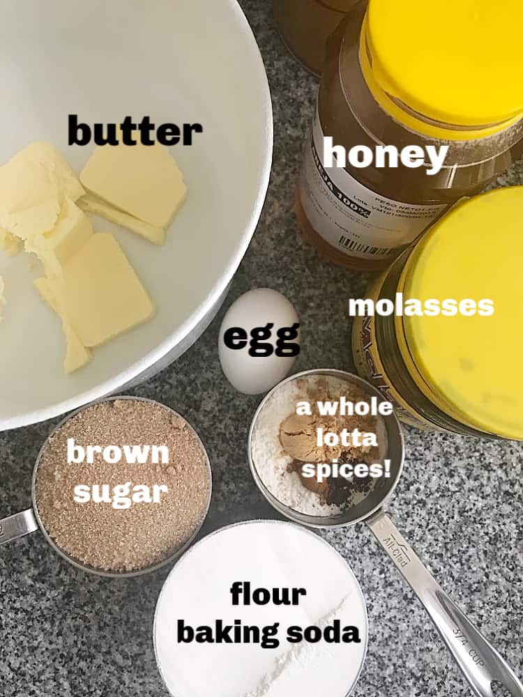 Bowl, cups and pots with ingredients for gingersnap cookies, including spices, molasses and honey