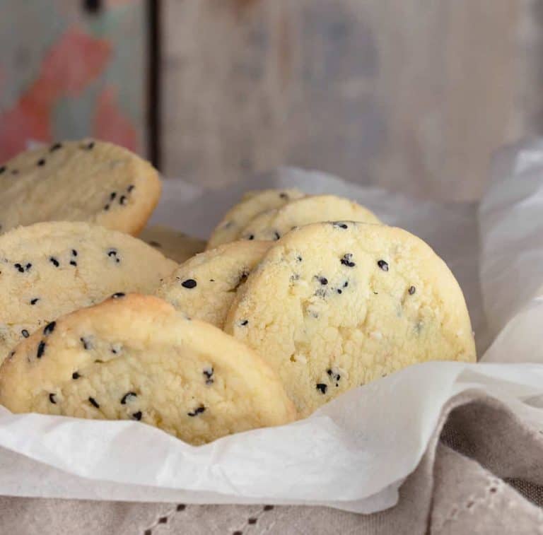 Sesame cookies over napkin and silk paper; wooden background