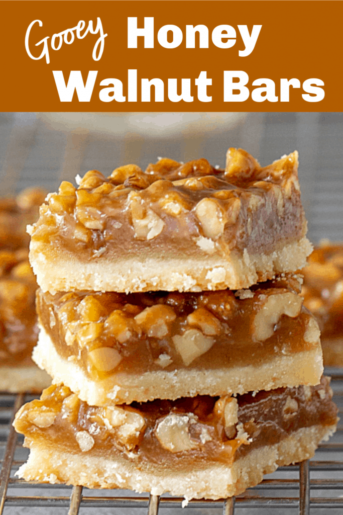Stack of honey walnut bars on wire rack, long pin with text