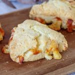 Baked cheese scone triangle on wooden board
