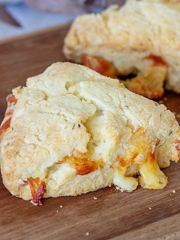 Baked cheese scone triangle on wooden board