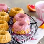 Glazed blood orange mini cakes on wire rack