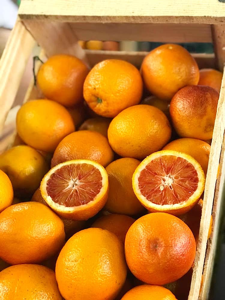 A wooden crate of blood oranges