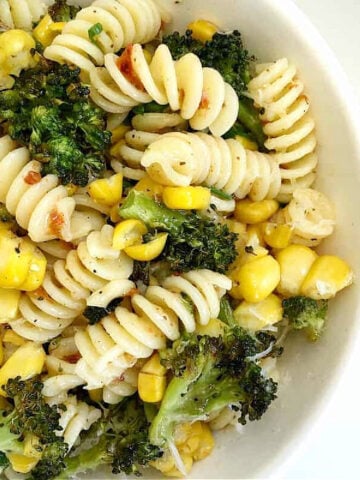 Broccoli corn pasta in a white bowl. Close up image.