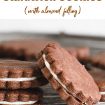 Round chocolate sandwich cookies on wire rack, long pin with text