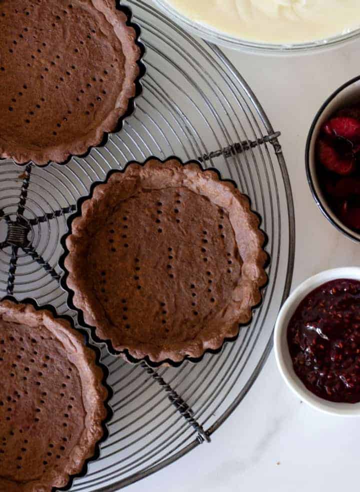 Round individual chocolate pie shells on wire rack, filling ingredients