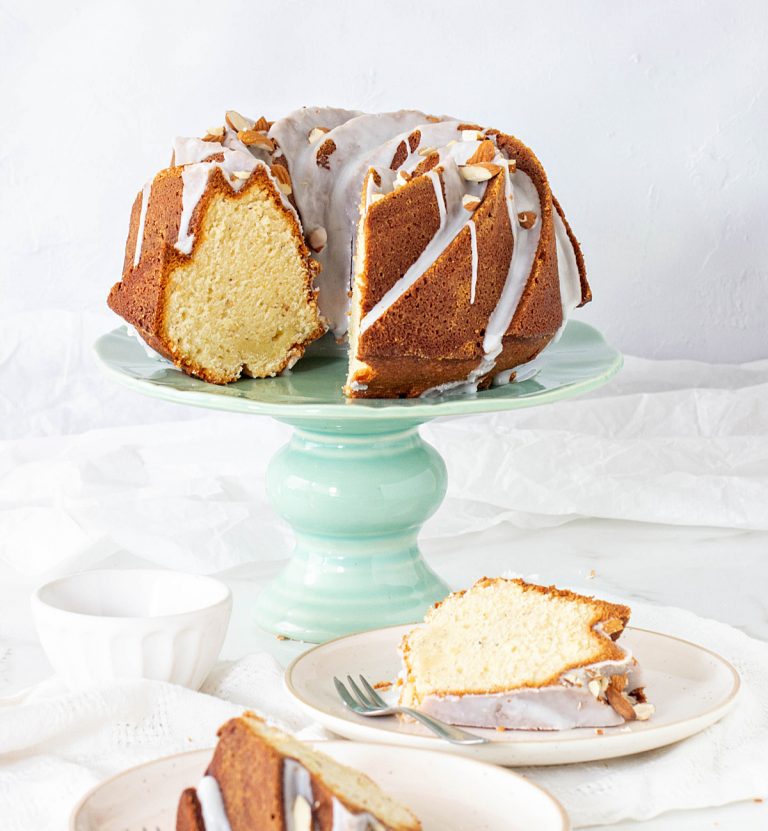 Green cake stand with glazed bundt cake, slices in plates, pin with text