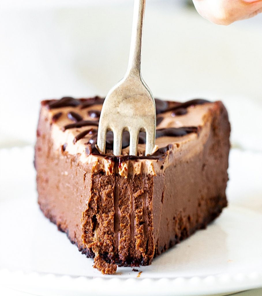 Sticking Silver fork into slice of chocolate cheesecake