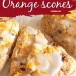 Close up of glazed scone triangle with orange zest, white and dark crimson text