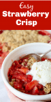 White bowl with strawberry crumble, scoop of ice cream, silver spoon