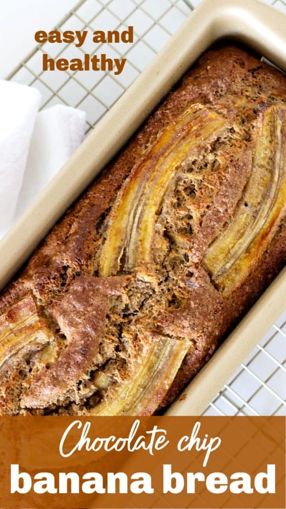 Overview of banana bread in metal pan on white kitchen towel
