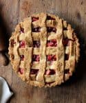Whole lattice Pie on wooden table, rolling pin