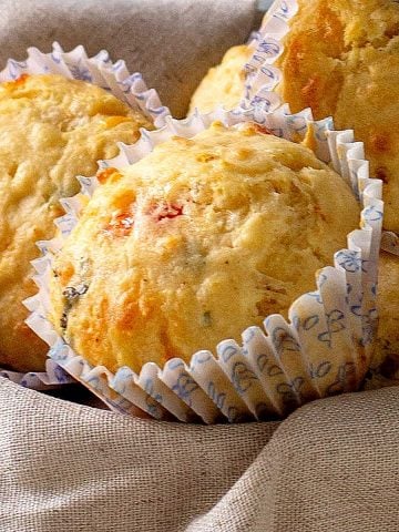 Close up savory muffins on a beige cloth.