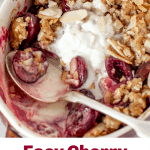 Close-up of silver spoon inside white individual dish with cherry crisp dessert; image with text