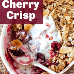 An oval dish with a half-eaten cherry crumble, silver spoon; image with text