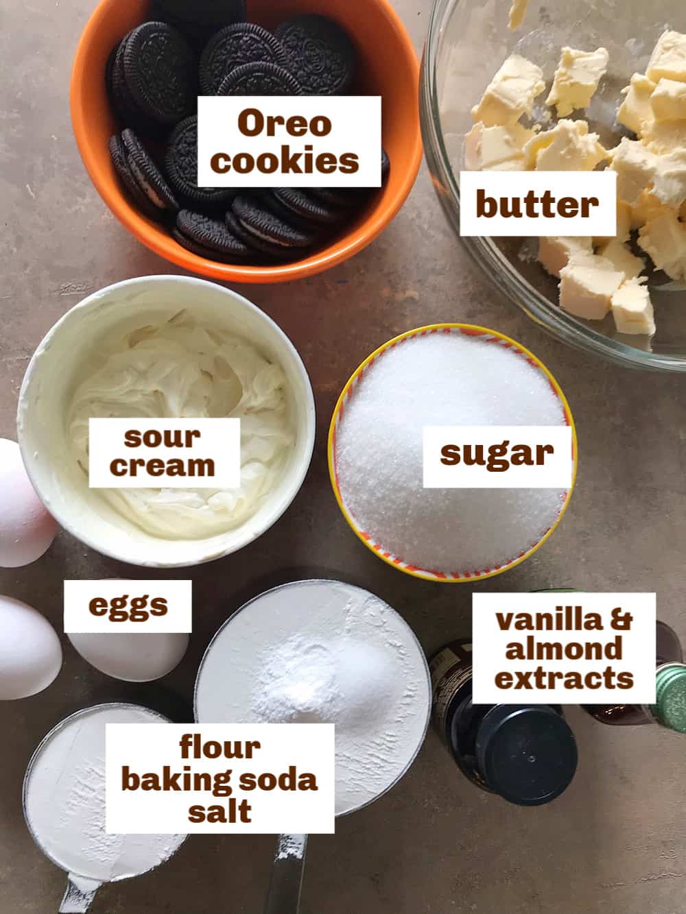 Brownish surface with ingredients in different sized and colored bowls