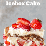 A serving of strawberry cream cake on grey background; image with text