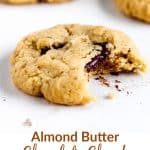 Bitten single cookie on a white surface; image with text