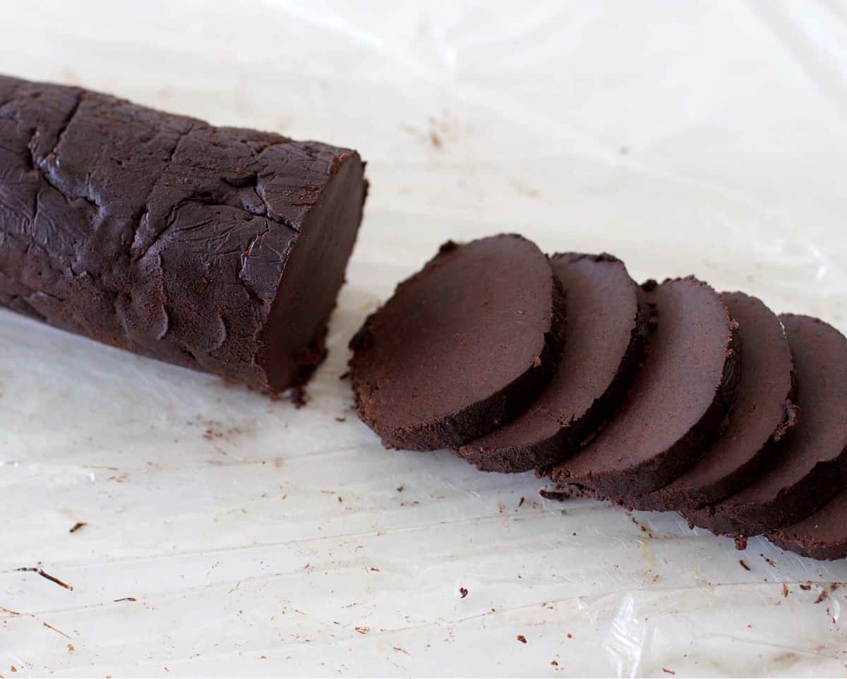 Cut circles of chocolate dough from a log, plastic paper underneath