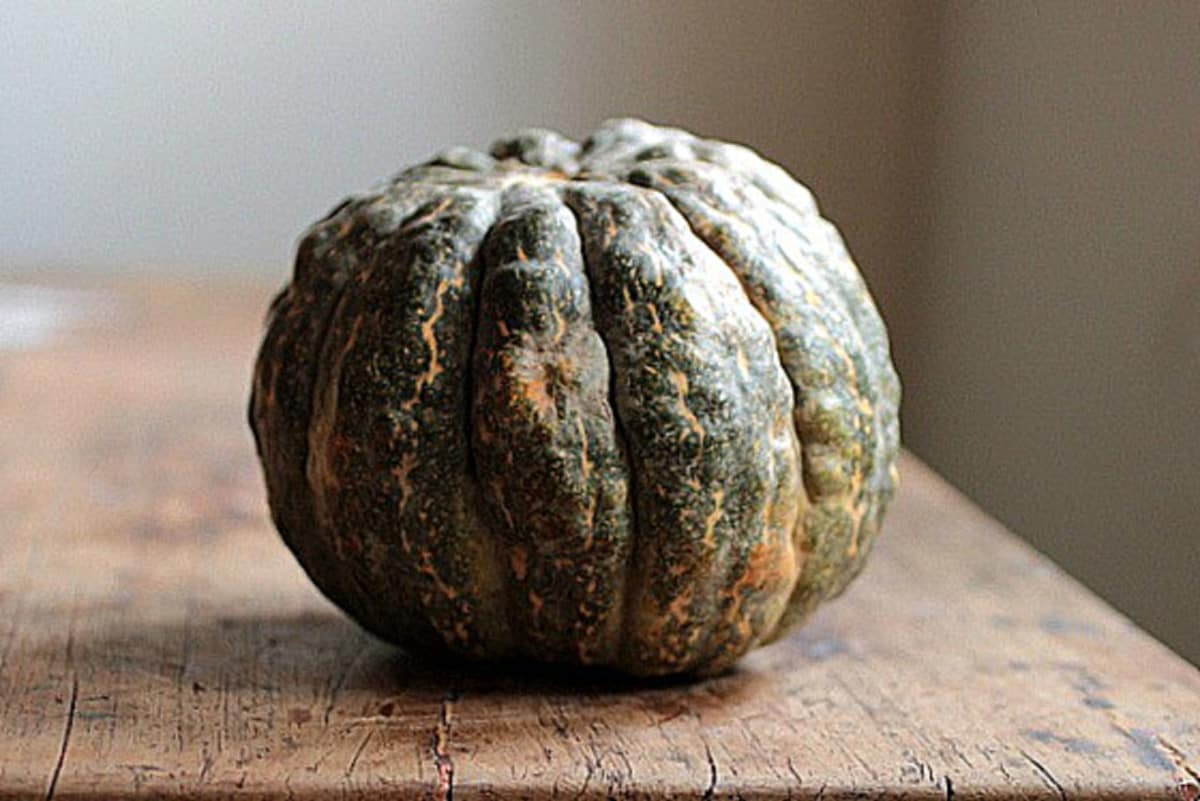 Whole green English Pumpkin on a wooden table