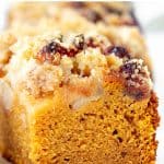 Close up of square of pumkin crumb cake, white background; image with text