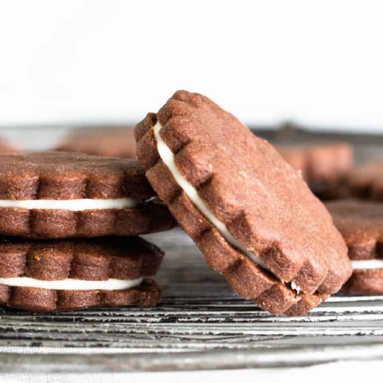 Close-up of round chocolate sandwich cookies on wire rack