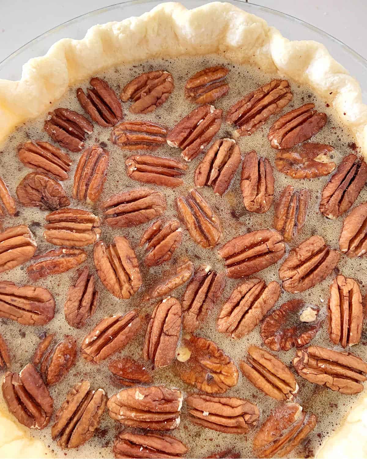 Pecan pie filling in the pre baked pie shell.